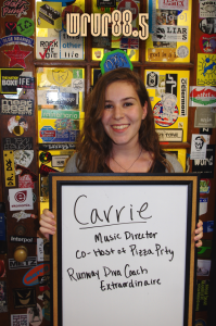 Carrie (Music Director and FM DJ) in front of the Sticker Door