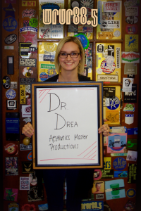 Dr. Drea (Aesthetics Master and Productions) in front of the Sticker Door