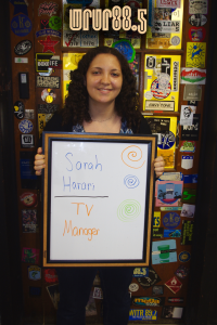 Sarah (WRUR-TV manager) in front of the Sticker Door